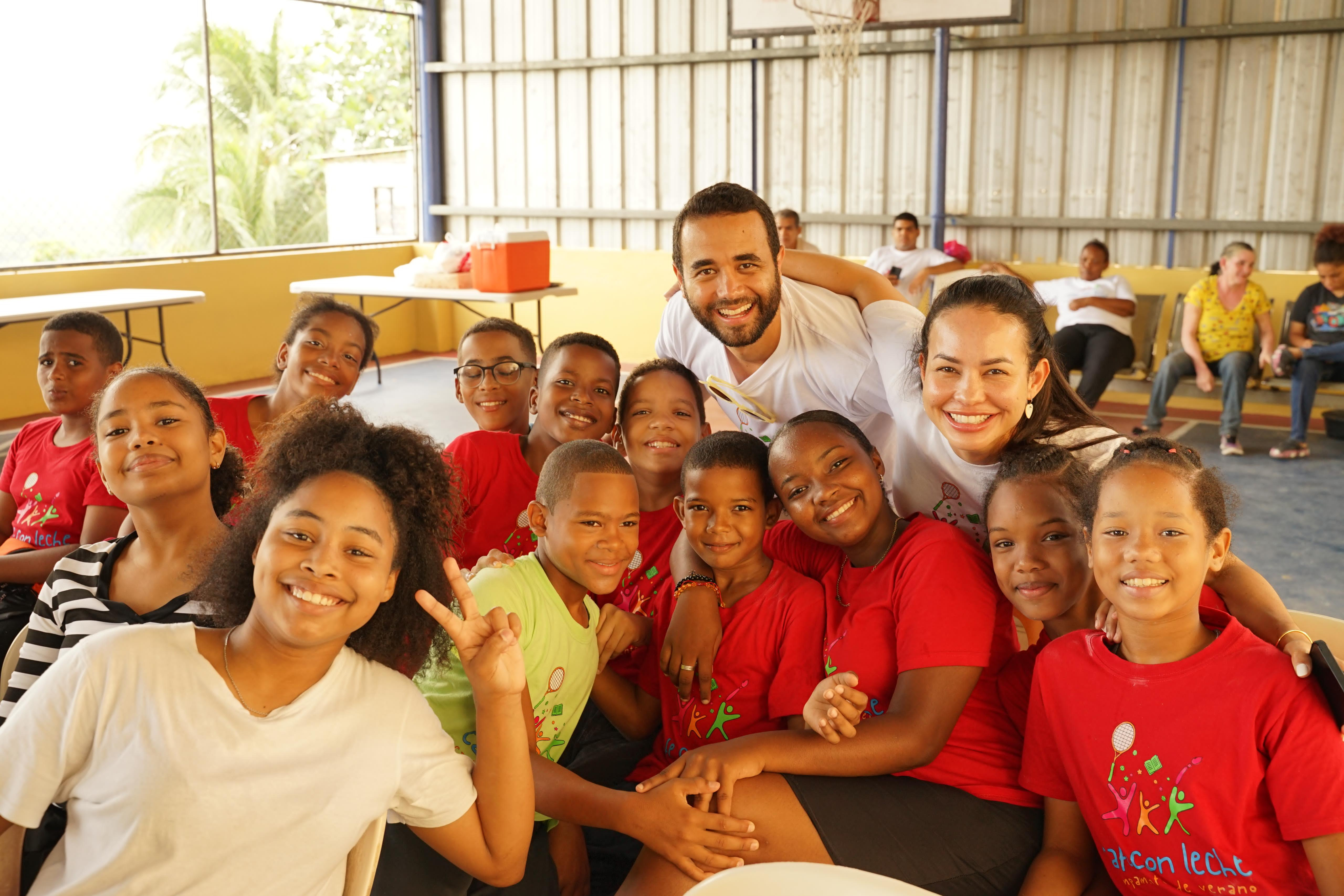 Campers and camp leaders smile together. 