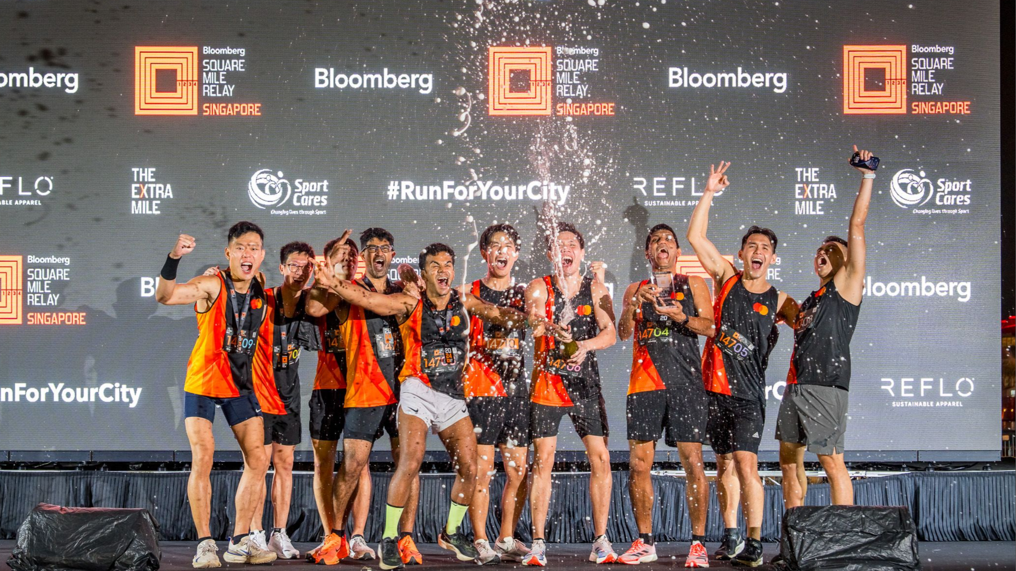 Mastercard runners celebrating their third place win at the Singapore Bloomberg Square Mile Relay.