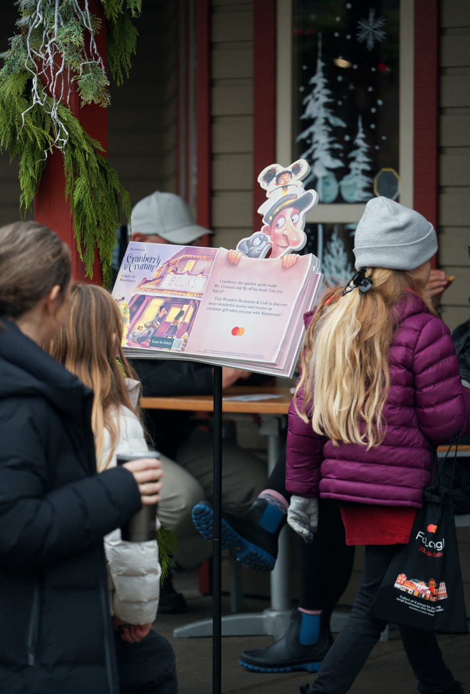 Shoppers in Fort Langley, B.C. go into a story in the town's historic downtown, past a copy of Mastercard's storybook "Cranberry & Crumm."