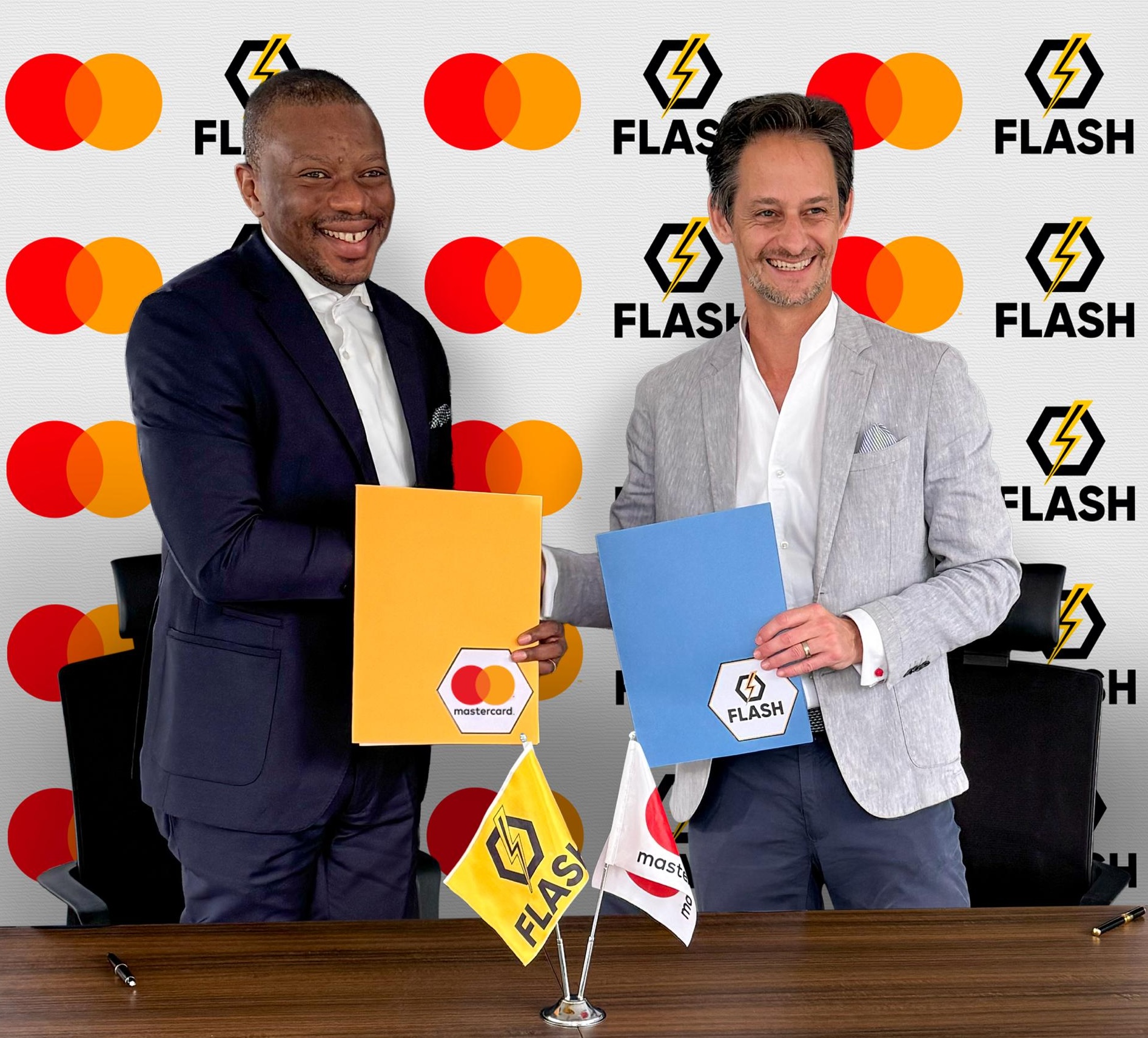 Left: Paul Muamba, Country Director, DRC, Mastercard Right: Jonathan Johannesen, CEO, Flash at the signing ceremony
