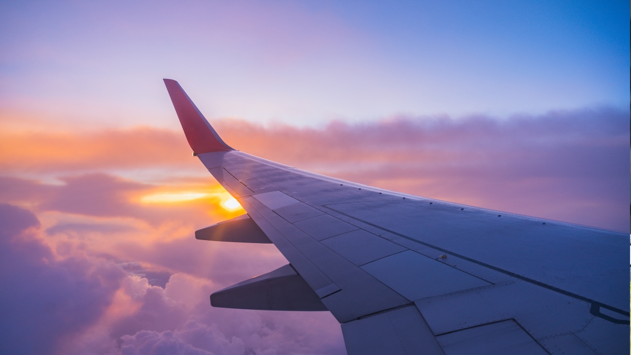 A plane's wing at sunset.