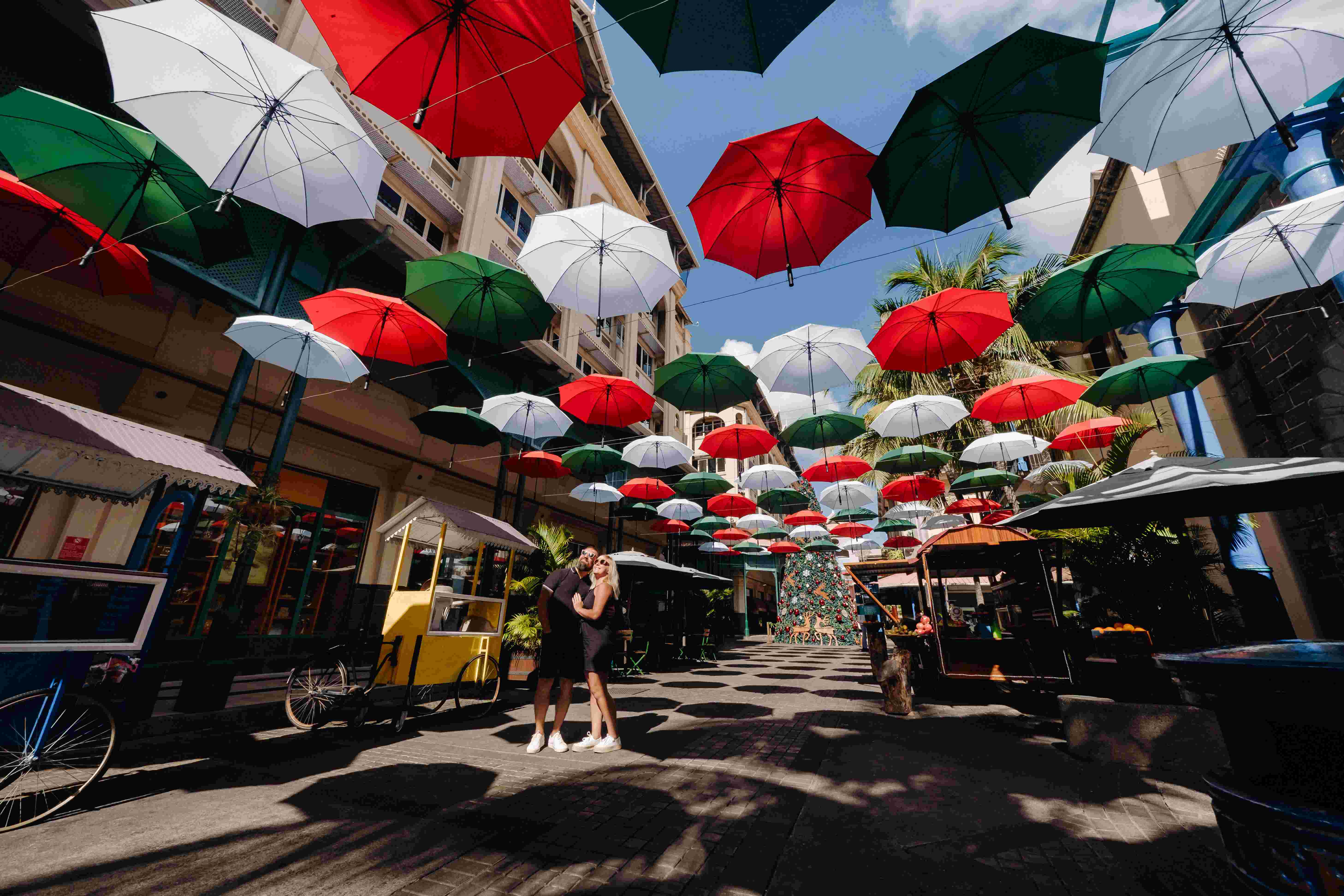 A shopping street in Port Louis, Mauritius's capital, lined with colorful umbrellas forming a canopy.